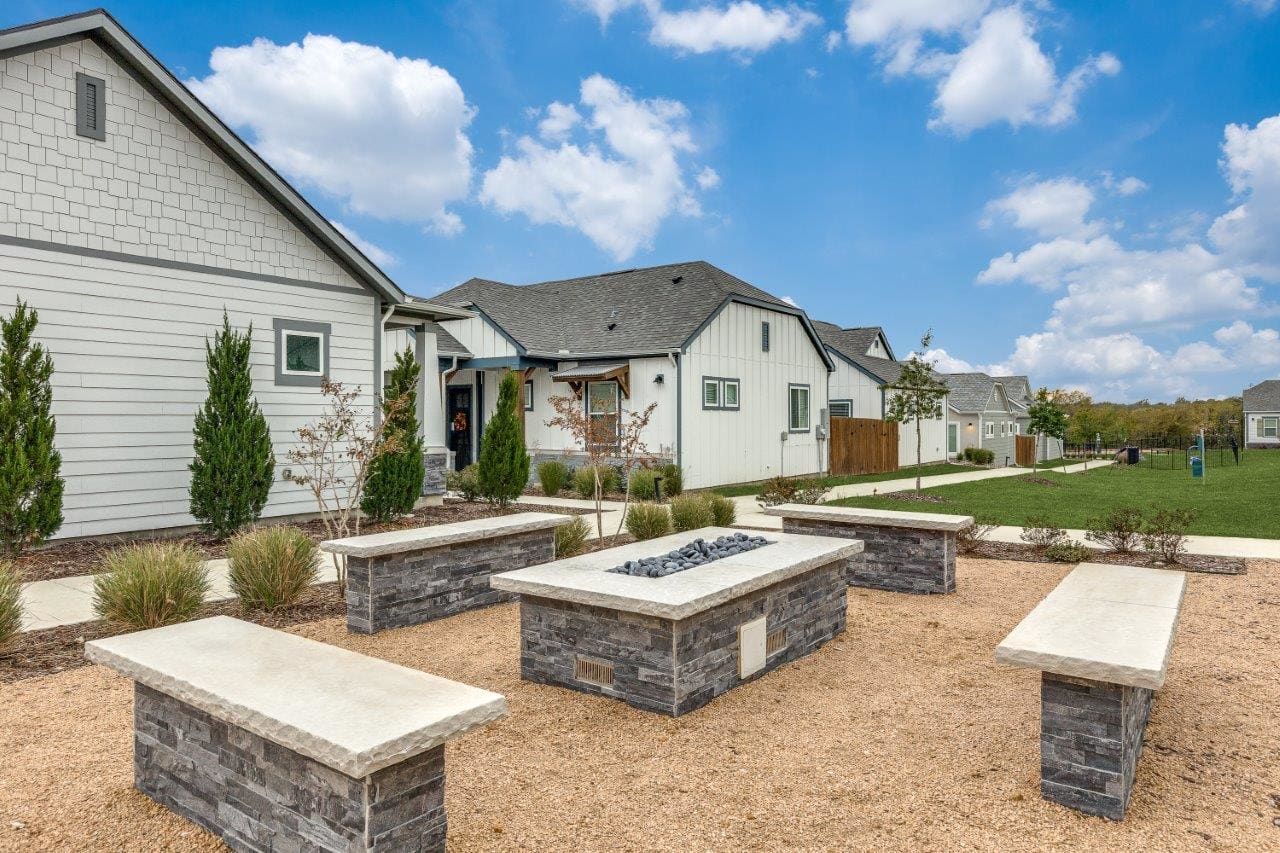 There is a fire pit in the middle of the yard.