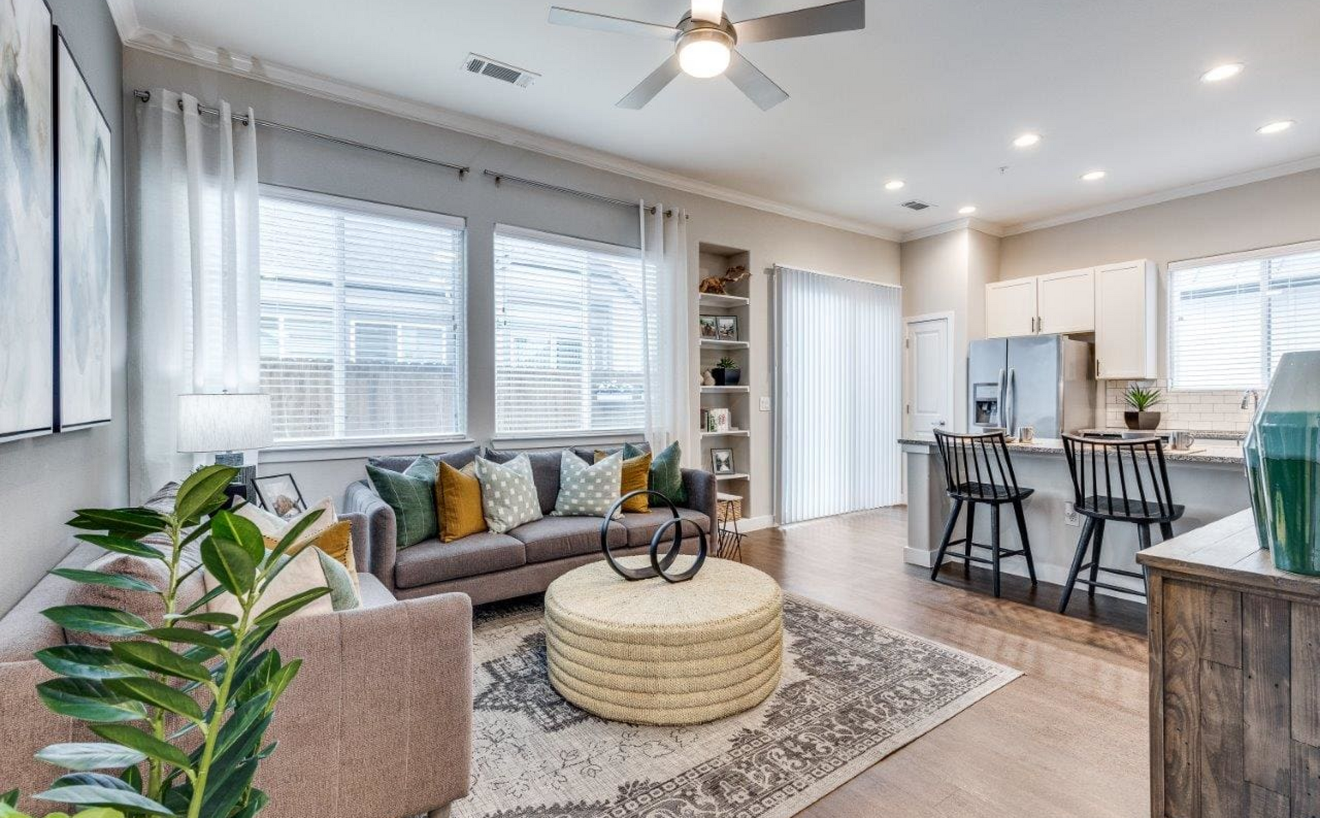 A living room filled with furniture and a ceiling fan.