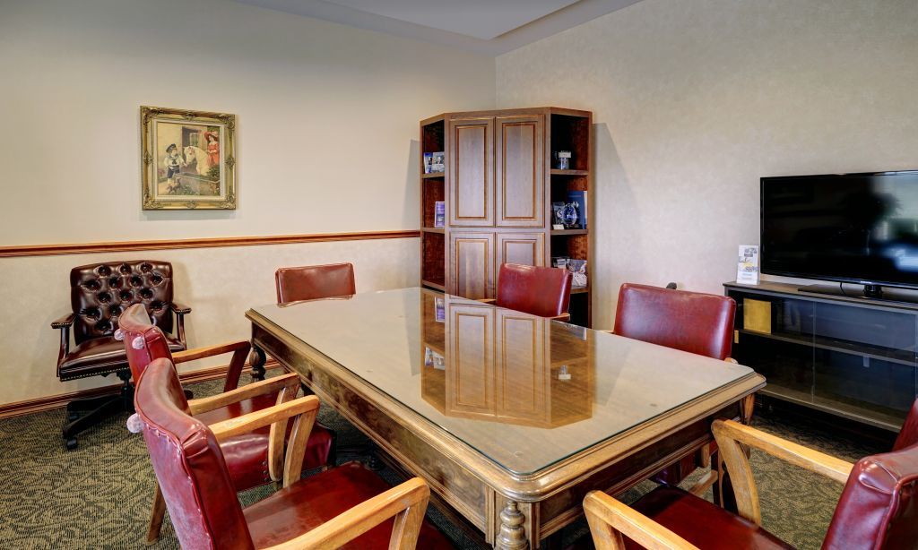 A conference room with a large table and chairs