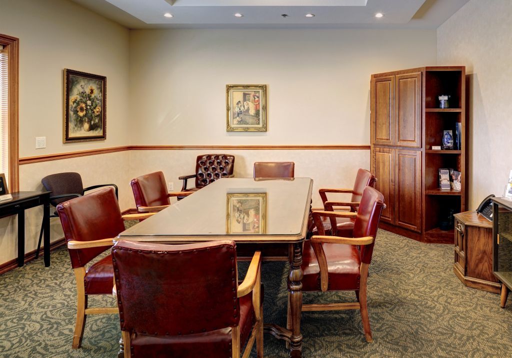 A conference room with a long table and chairs