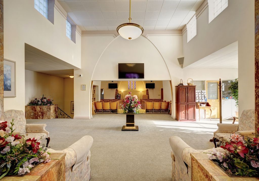 A large room with a table and chairs in it
