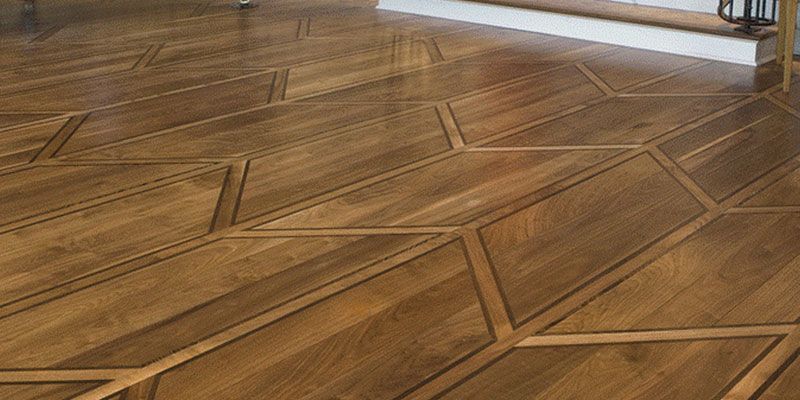 Wooden parquet floor with a geometric inlaid pattern in a room