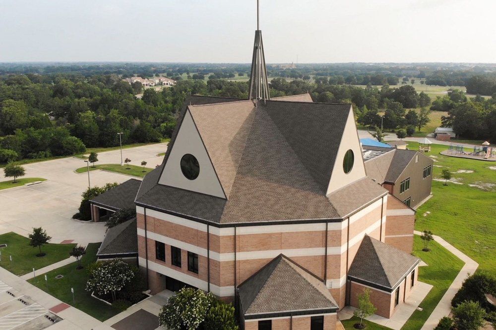 an aerial view of a church with a steeple