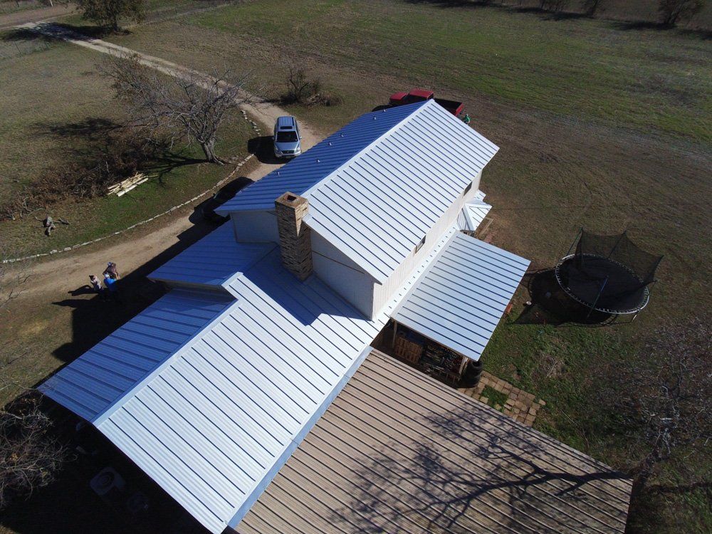 an aerial view of a house with a metal roof .
