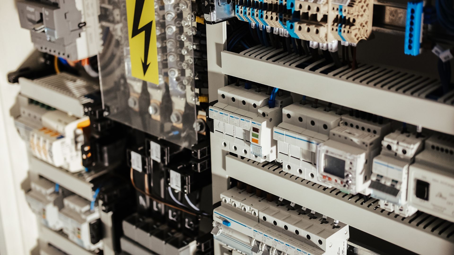 A close up of a electrical cabinet filled with lots of electrical equipment.