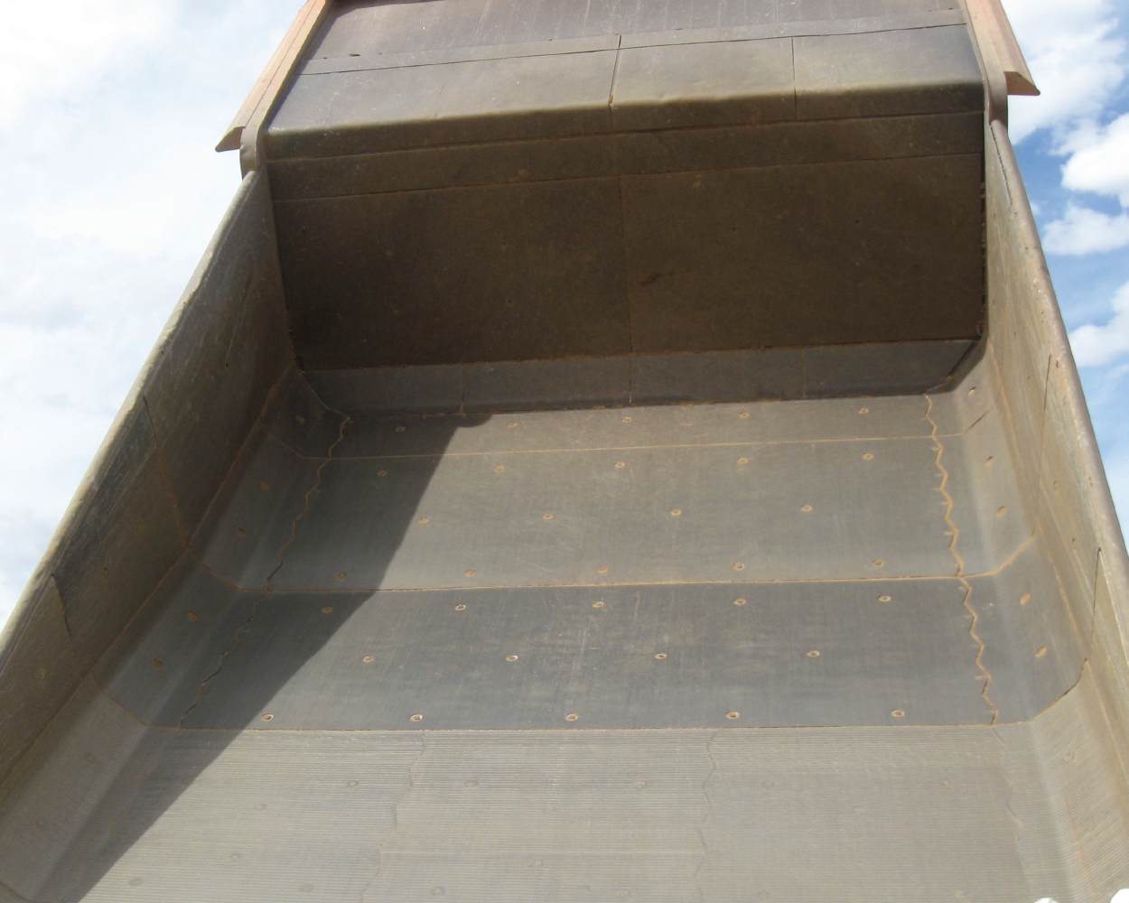 Smooth mining haul truck bed liner system - carbide overlay and AR500 - Surealloy and Vanguard
