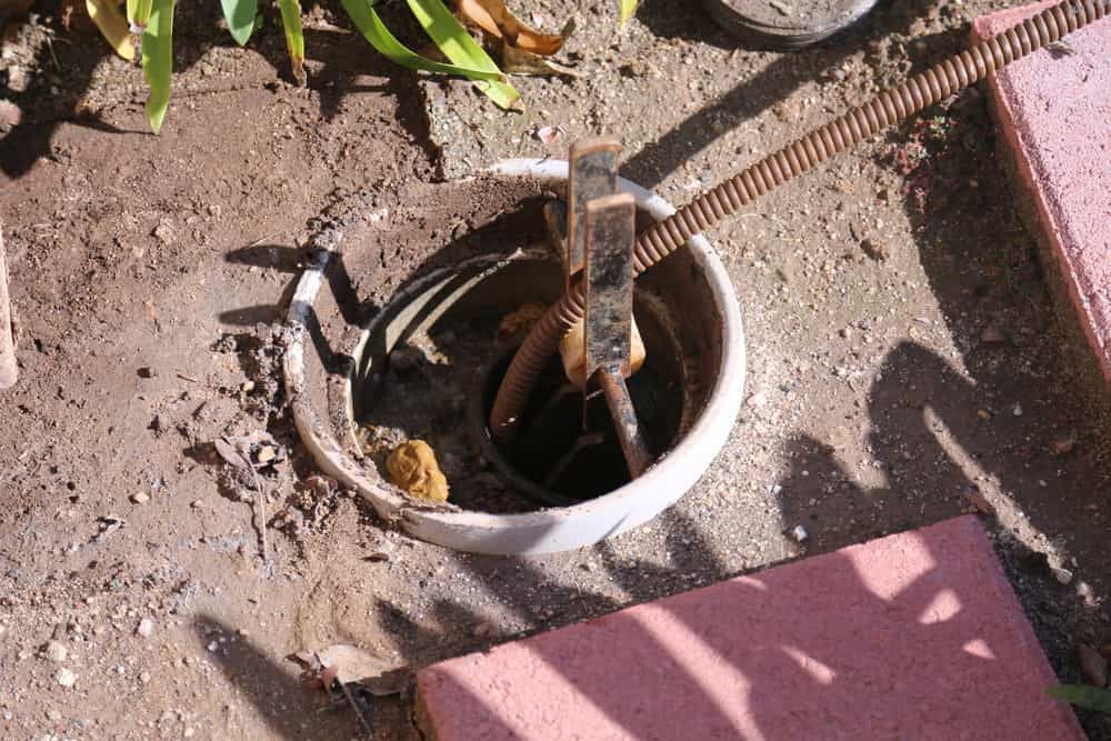 Hose Is Coming Out Of A Hole In The Ground — Russell Plumbing In Manunda, QLD