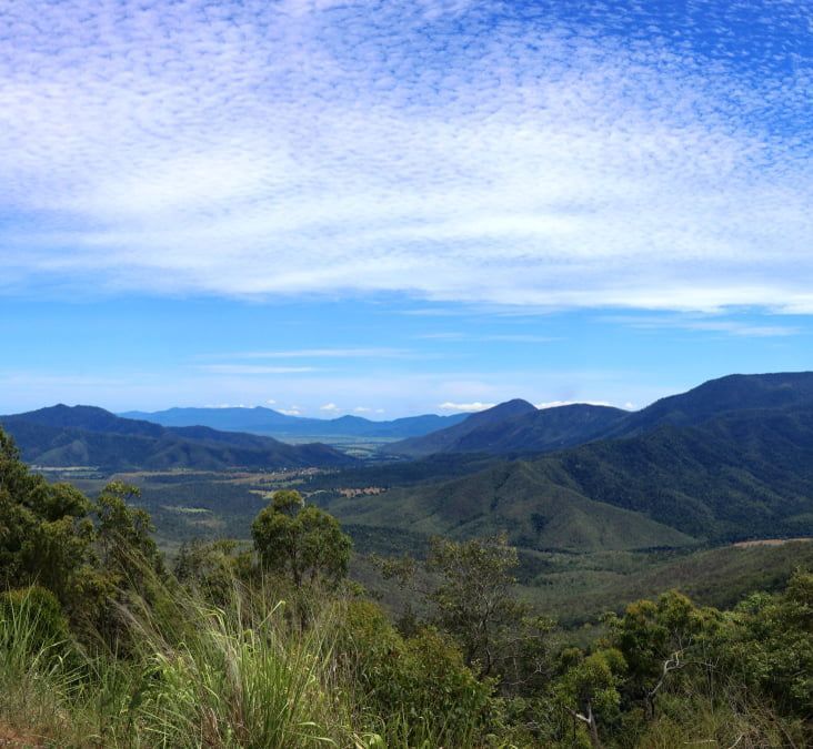 A View Of A Valley With Mountains And Trees On A Sunny Day — Russell Plumbing In Gordonvale, QLD