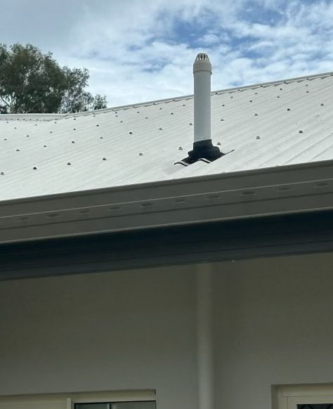 A White Roof With A Chimney On Top Of It — Russell Plumbing In Manunda, QLD