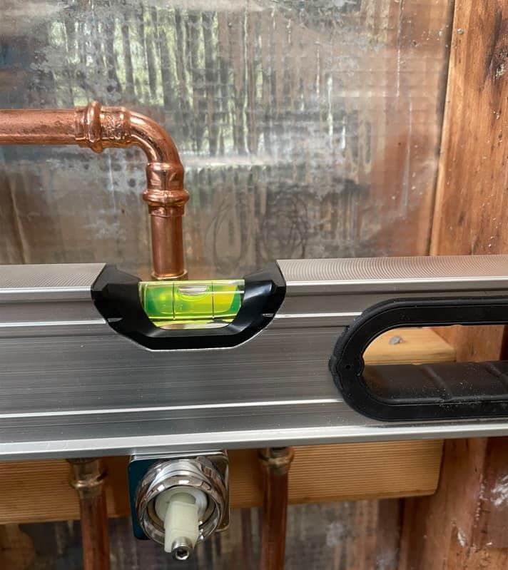 A Level Is Sitting On Top Of A Copper Pipe — Russell Plumbing In Manunda, QLD