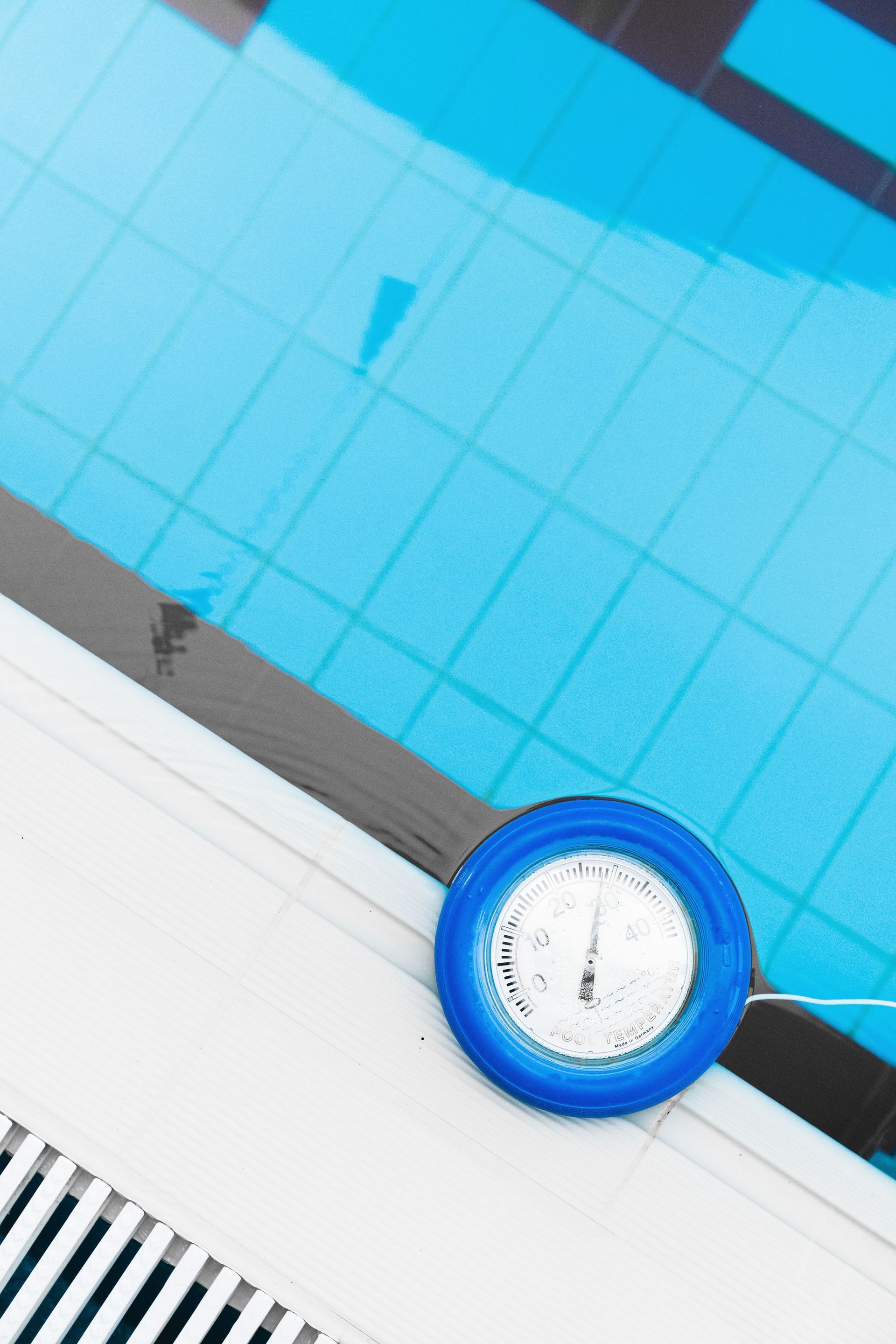 Blue pool lane marker floating on turquoise water next to the pool edge