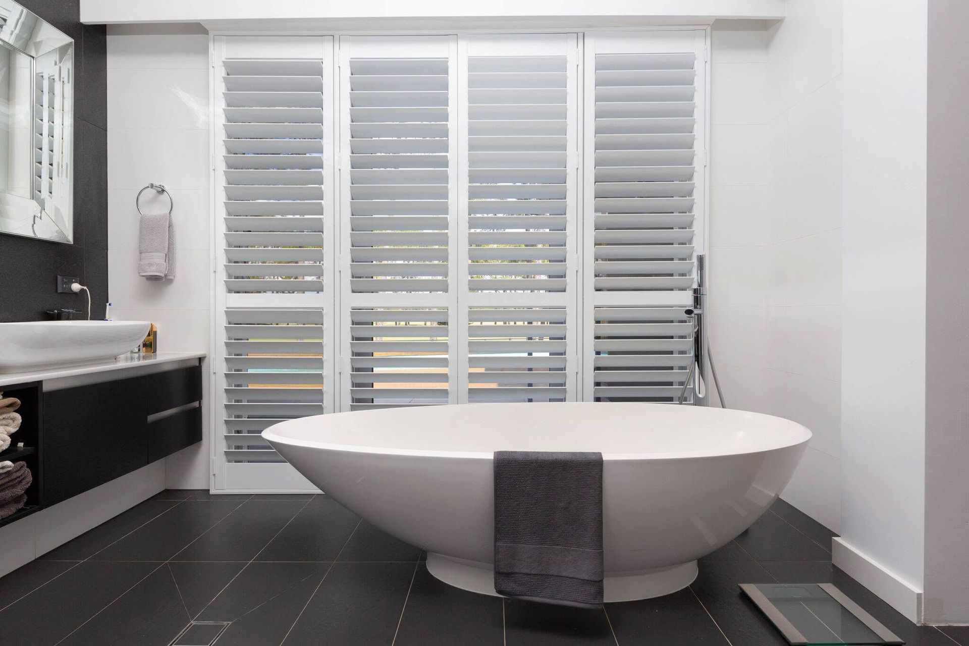 Bathroom With a Freestanding Tub, and Tall Shuttered Windows — Douglass Blinds & Security Screens in Wagga Wagga, NSW