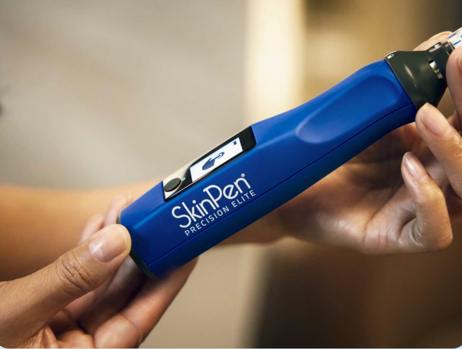 Blue SkinPen device held in hands, with a screen and the word