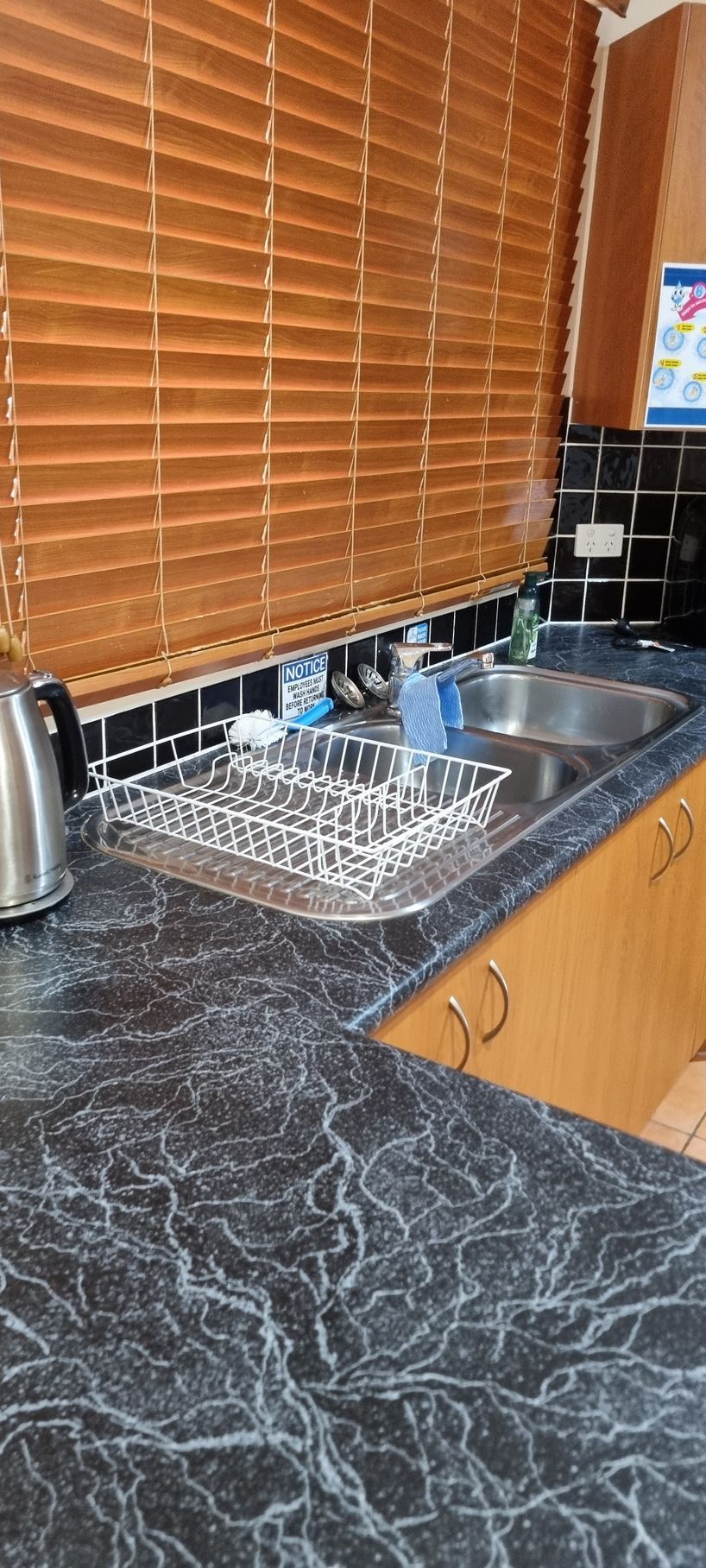 Kitchen Counter With Sink, Dish Rack, and Blinds — RWM Cleaning in Deception Bay, QLD