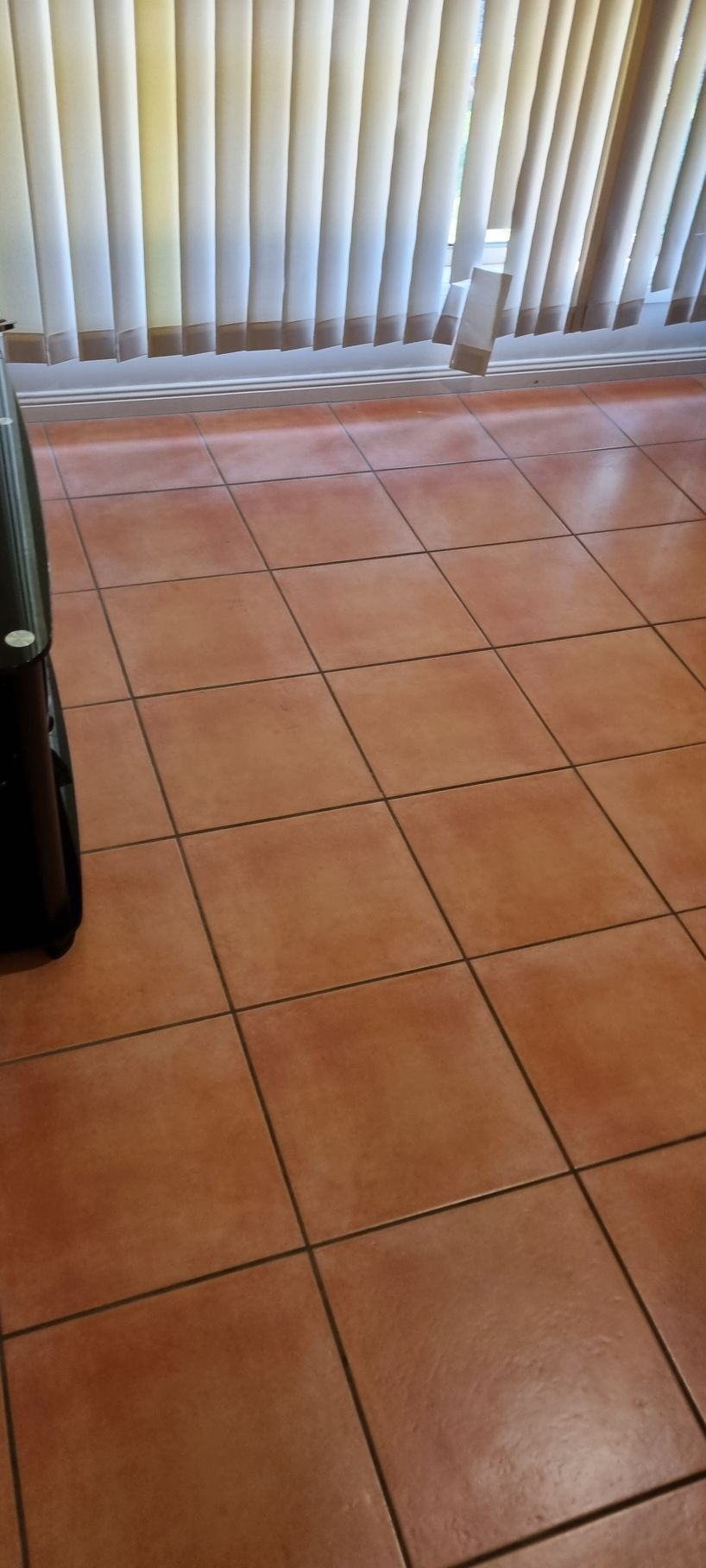 Terracotta tile floor with vertical blinds in the background — RWM Cleaning in Deception Bay, QLD