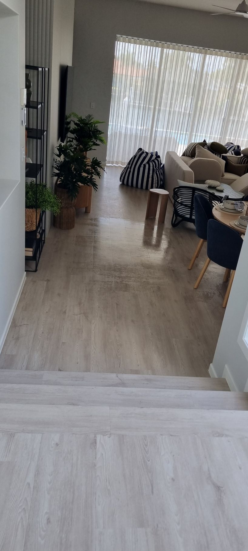 View From Top of Stairs Into a Living Room With Wooden Floors — RWM Cleaning in Deception Bay, QLD