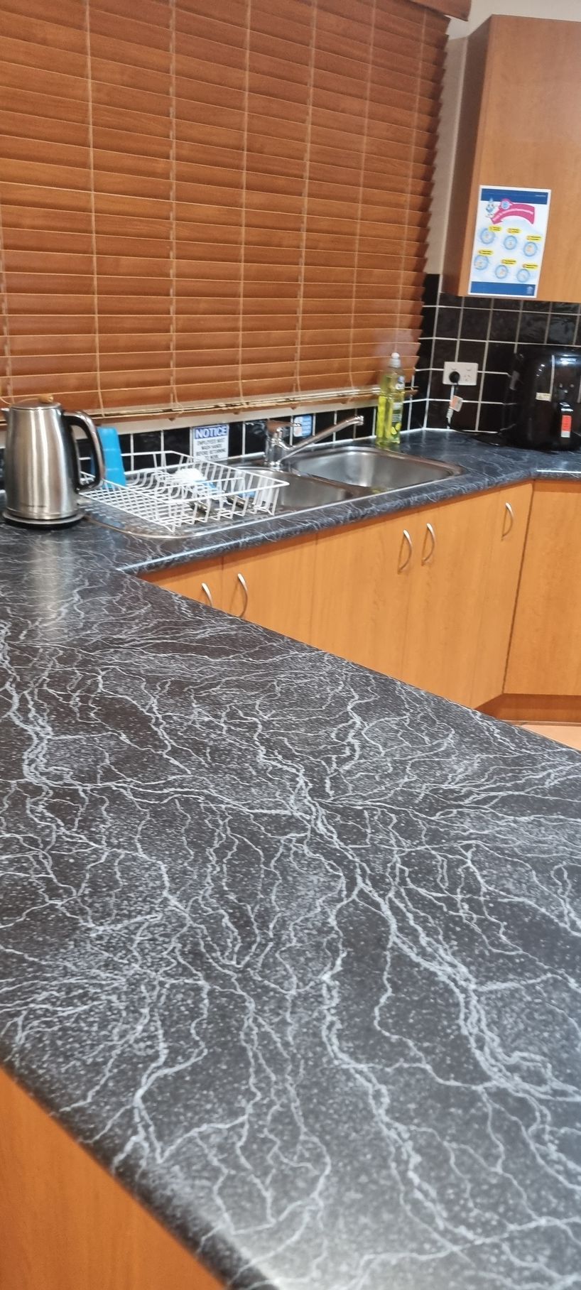 Kitchen Countertop With Black and White Marbled Pattern — RWM Cleaning in Deception Bay, QLD