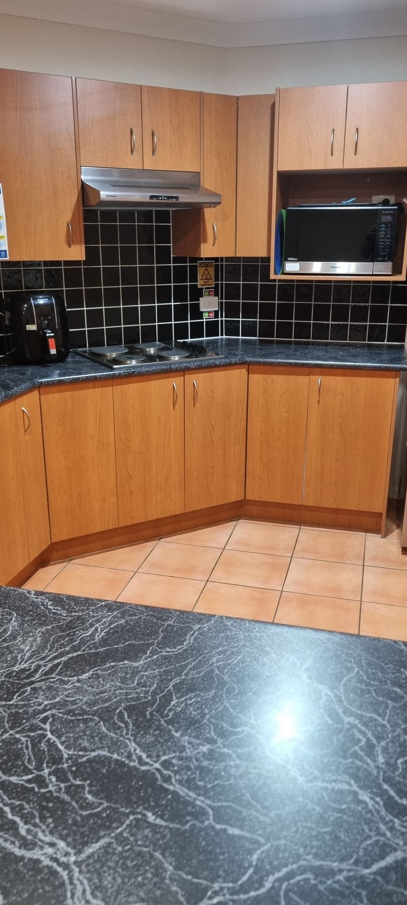 Kitchen With Light Brown Cabinets — RWM Cleaning in Deception Bay, QLD