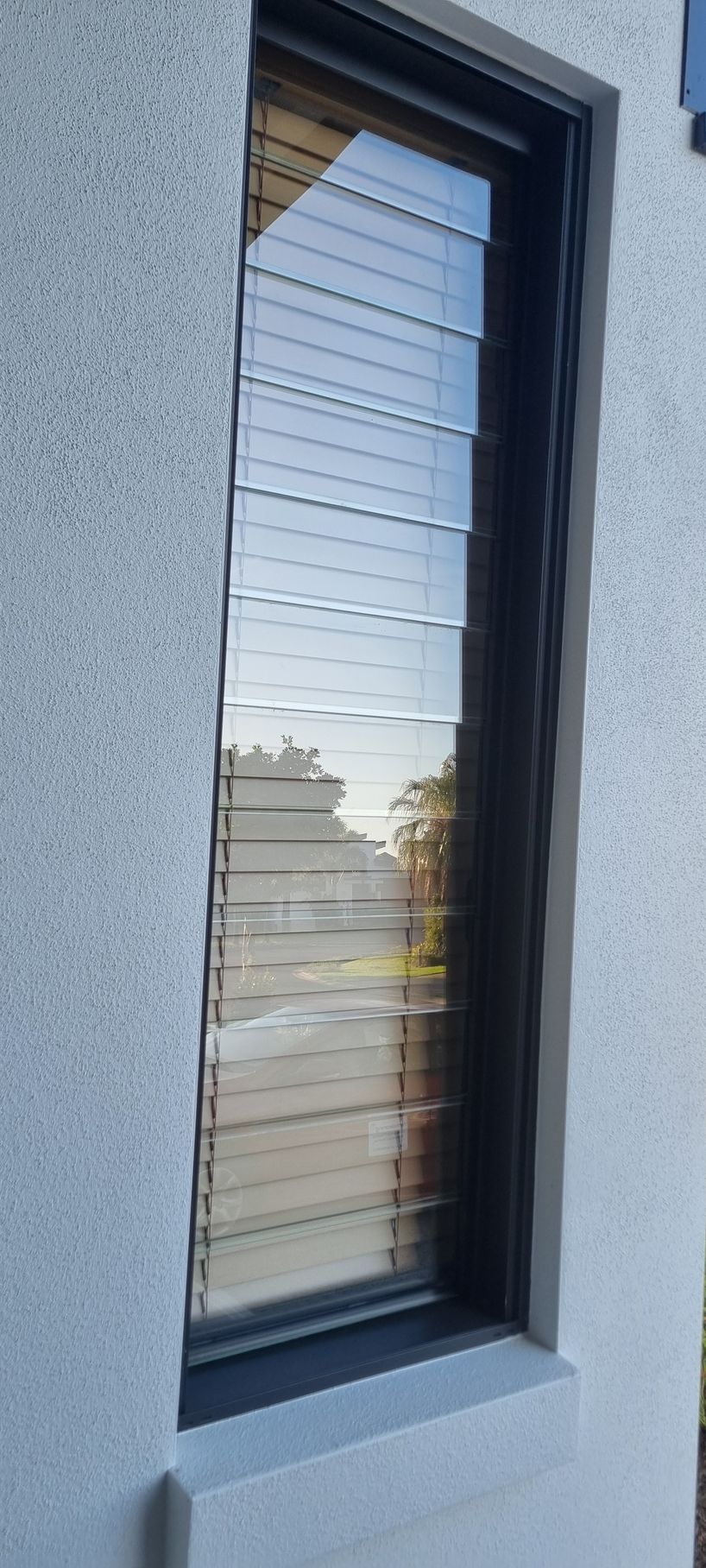 A Narrow, Rectangular Window With Horizontal Blinds — RWM Cleaning in Deception Bay, QLD
