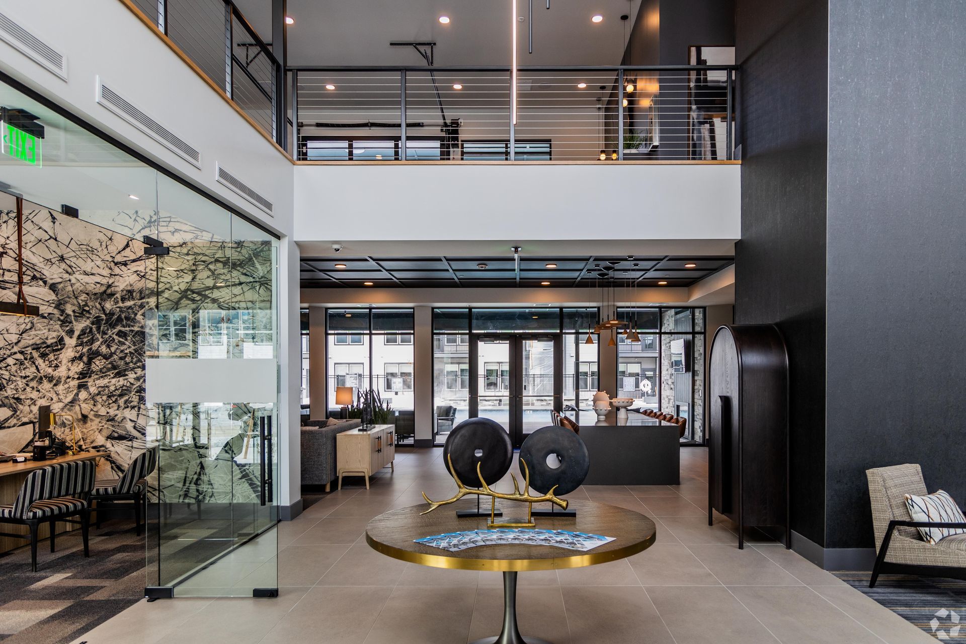 19th and Graf  Apartments Modern lobby with seating, art, and a two-story design.