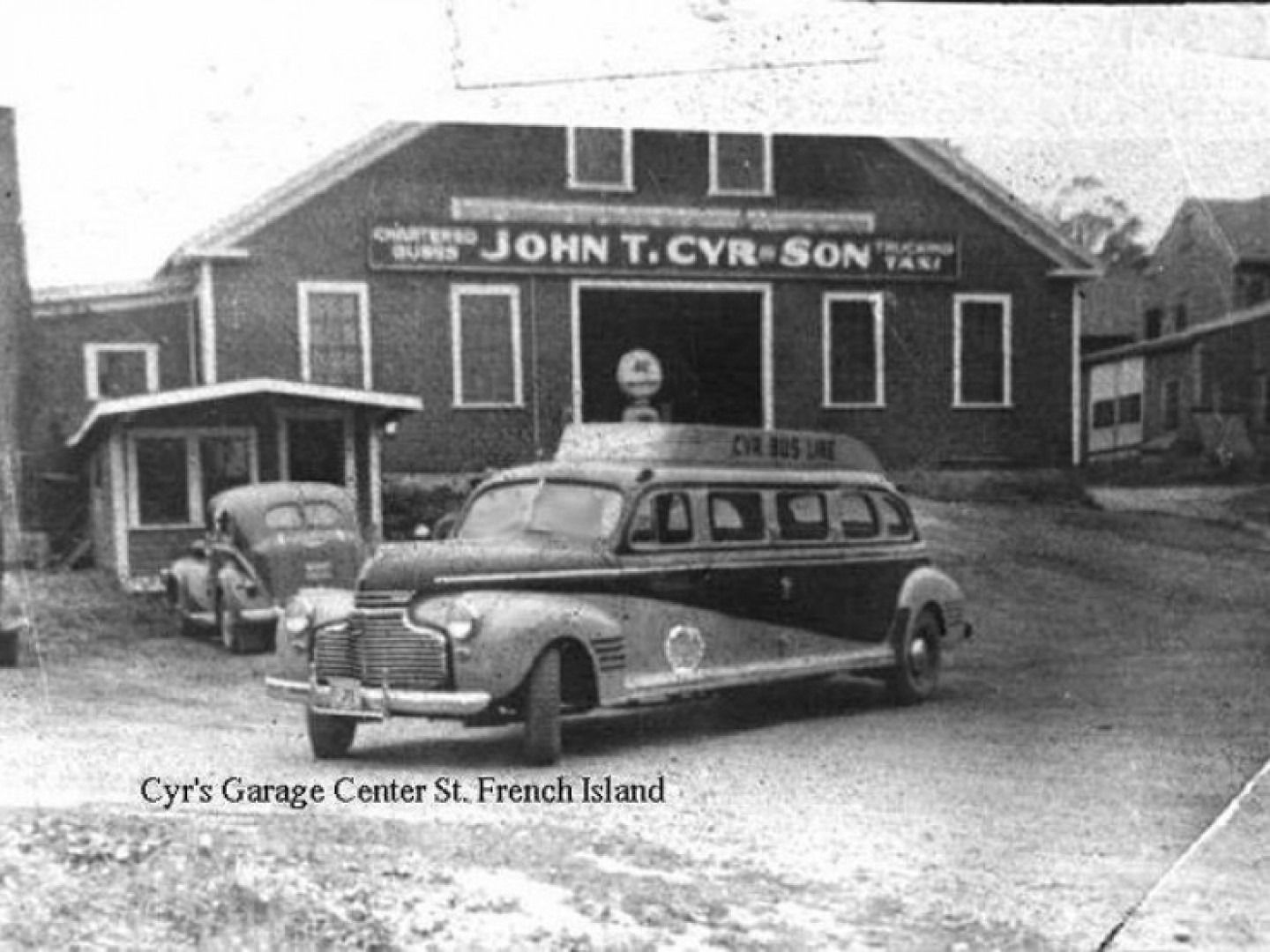 Vintage funeral home with hearse parked outside, marked “John T. Cyr Son” and “Cyr’s Garage Center St. Lewiston, Me.”