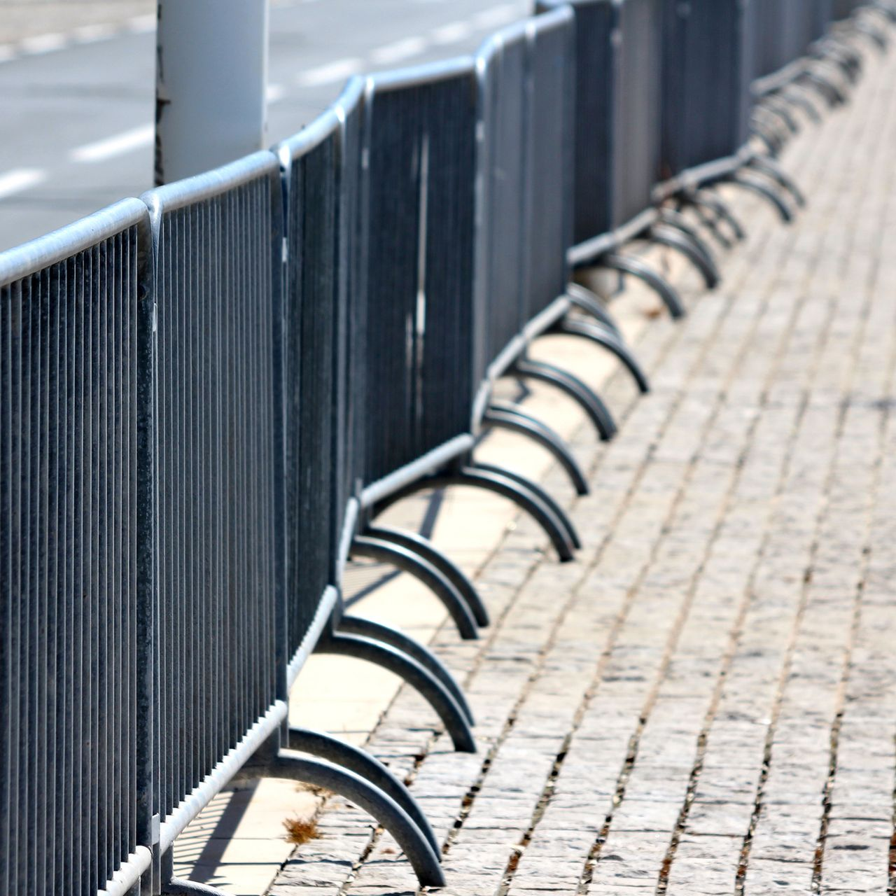 Steel crowd control fences lining a city street for organized pedestrian flow.