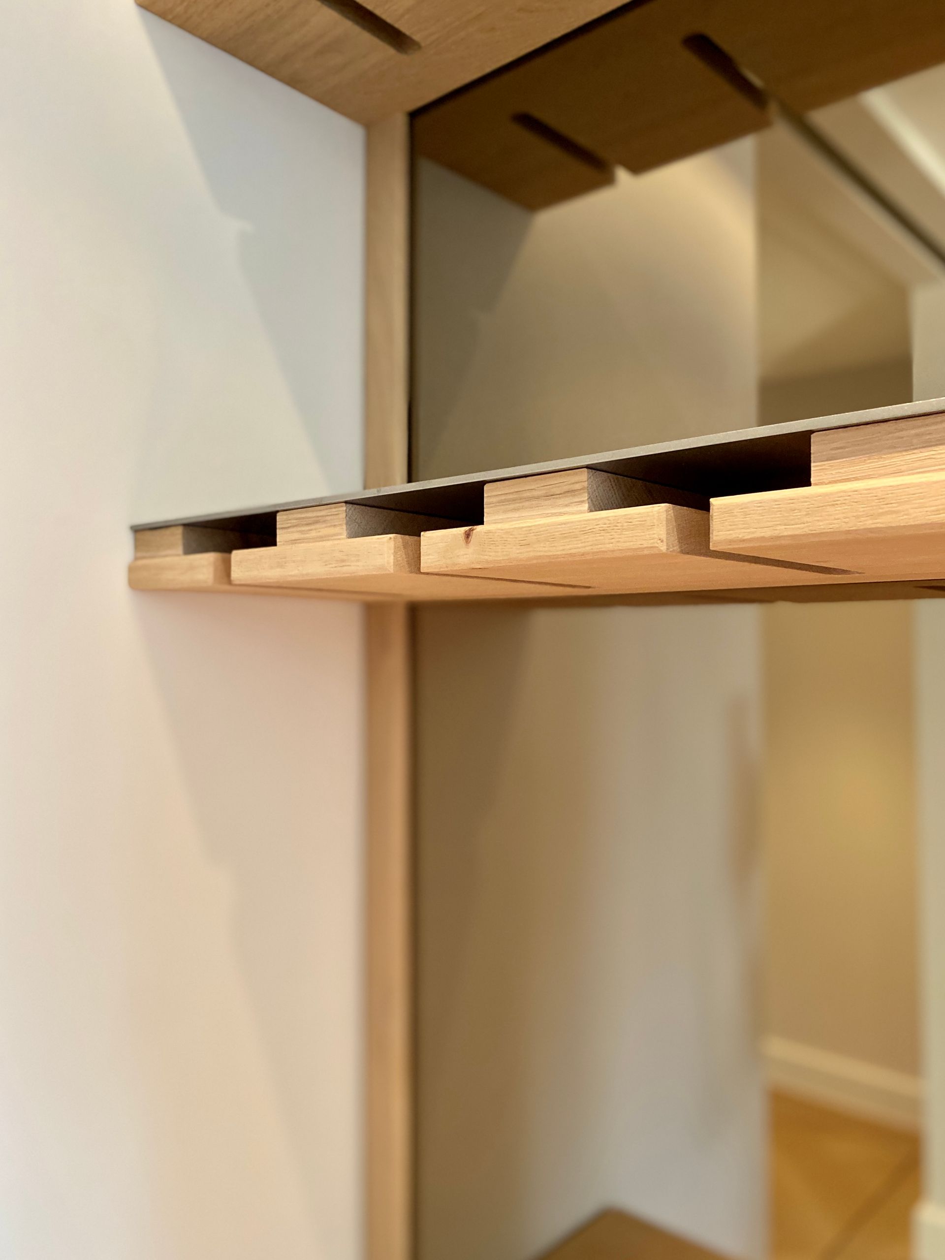 Houten plankdragers met een plank van licht hout, gemonteerd boven een dranken kast of bar | Villa18