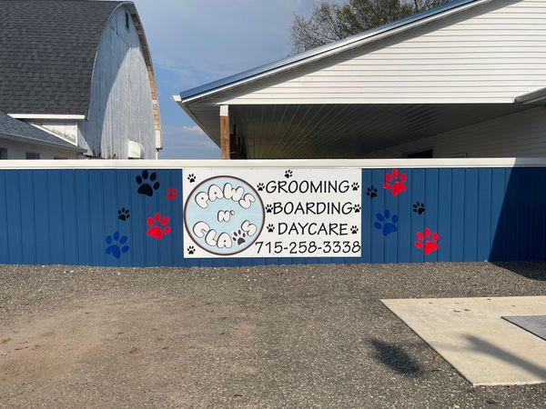 Blue fence with a sign for