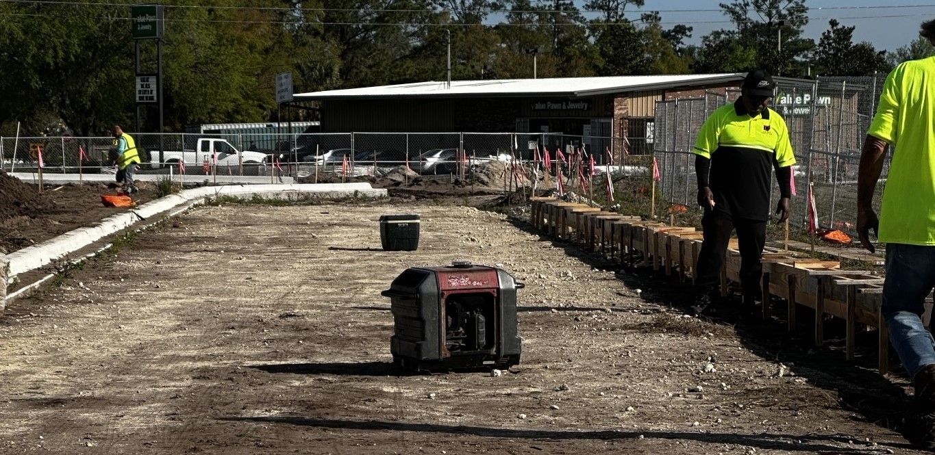 A group of construction workers are walking down a dirt road.