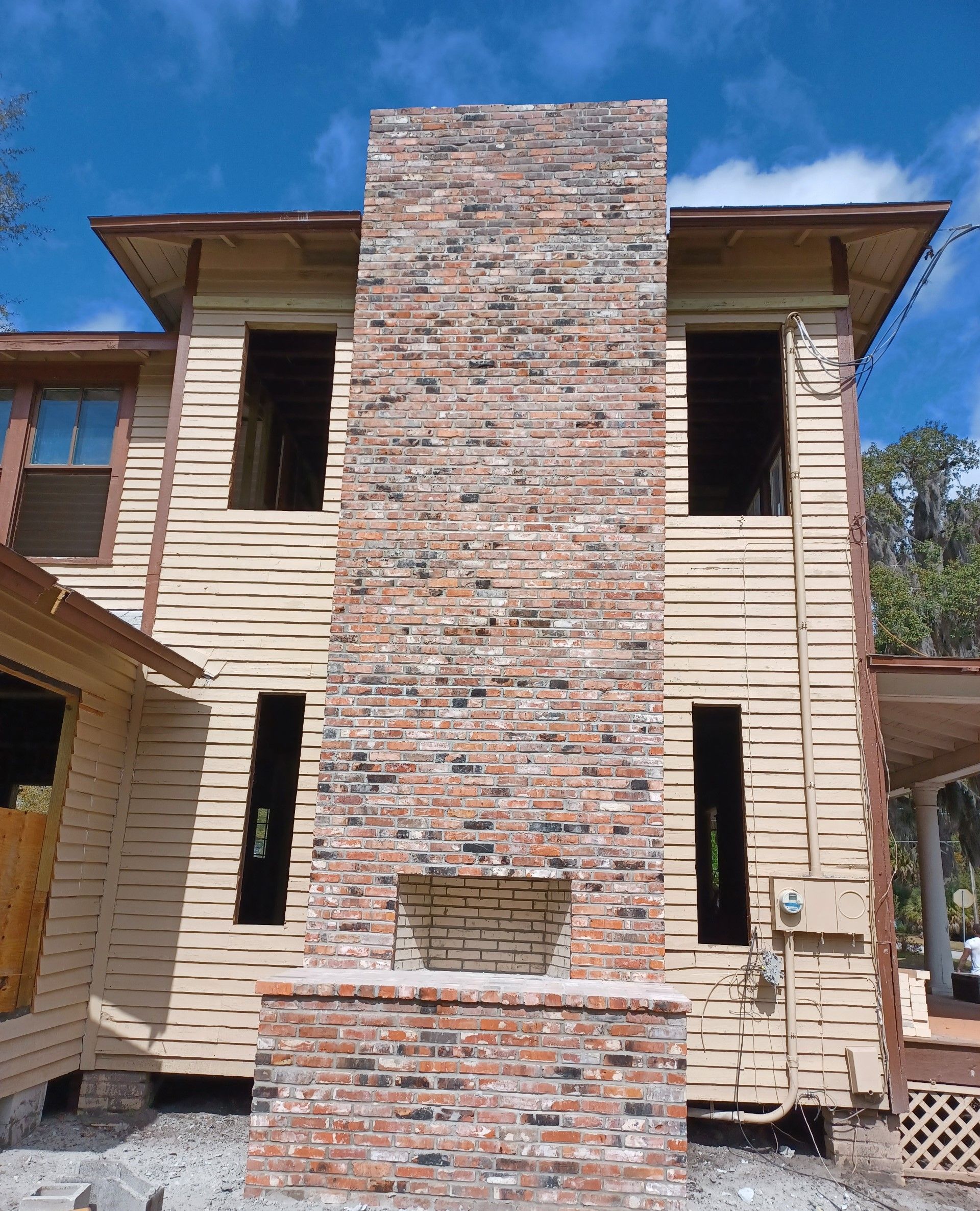 A large brick chimney on the side of a house