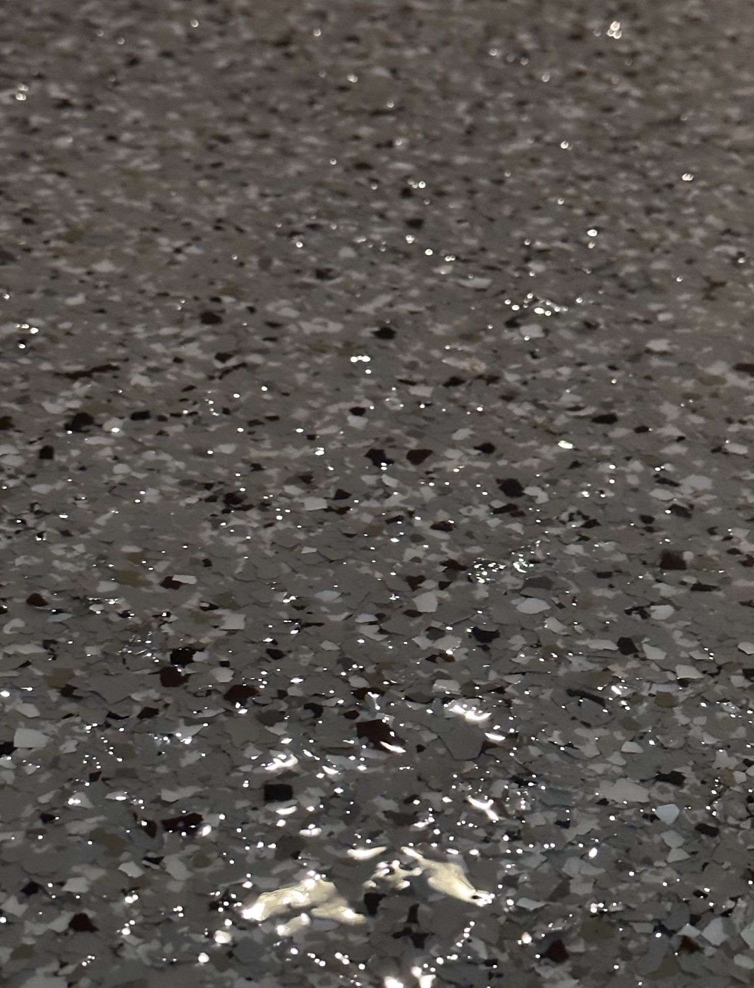 A concrete porch with salt and pepper flakes