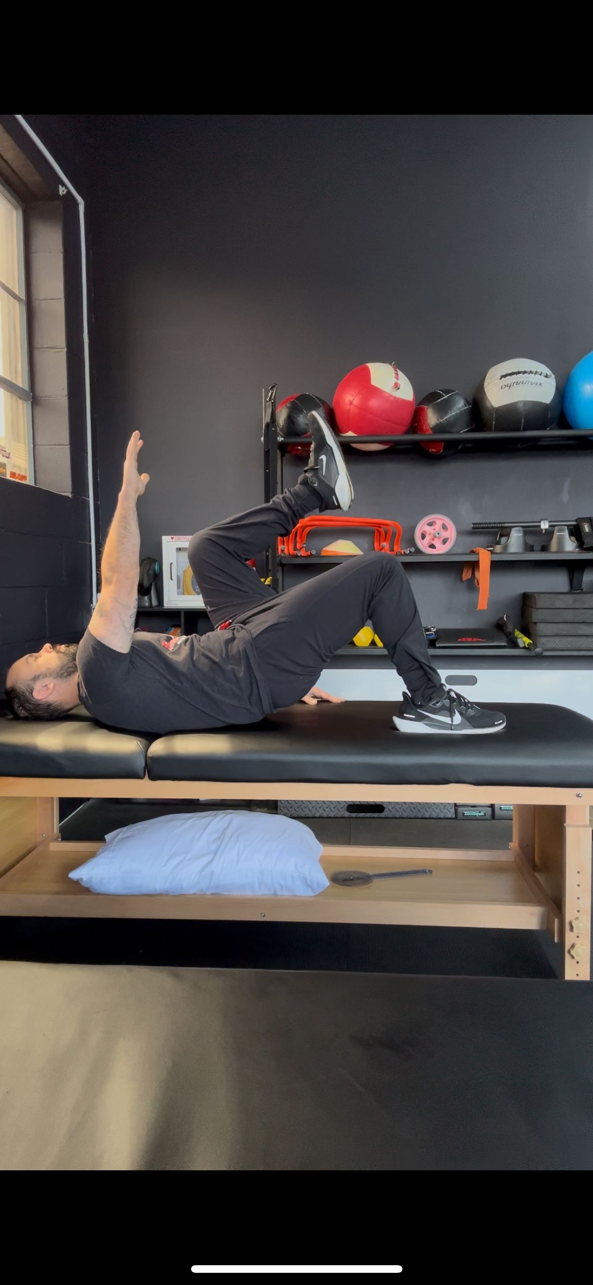 A man is laying on a bed doing exercises.