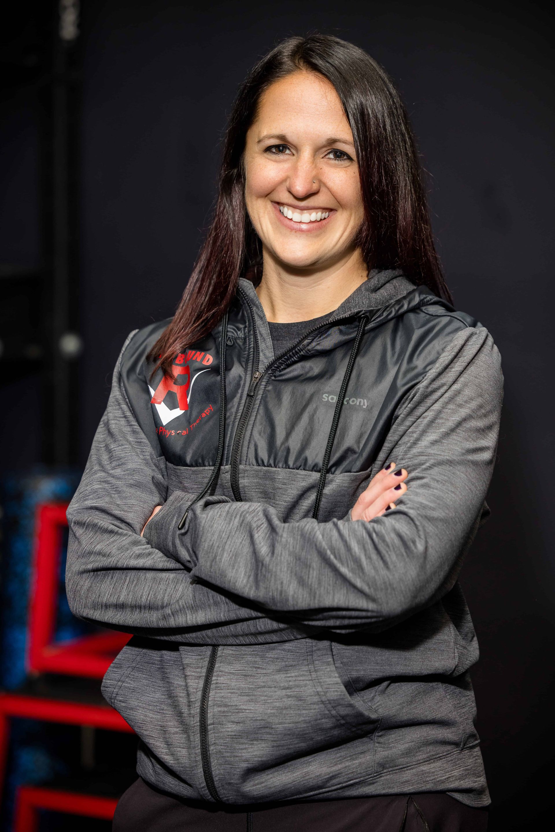 A woman wearing a black shirt with the letter r on it
