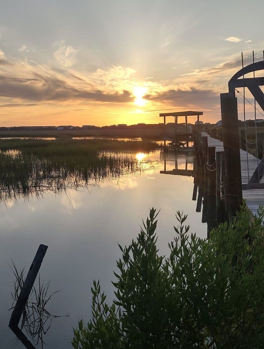 The sun is setting over a body of water