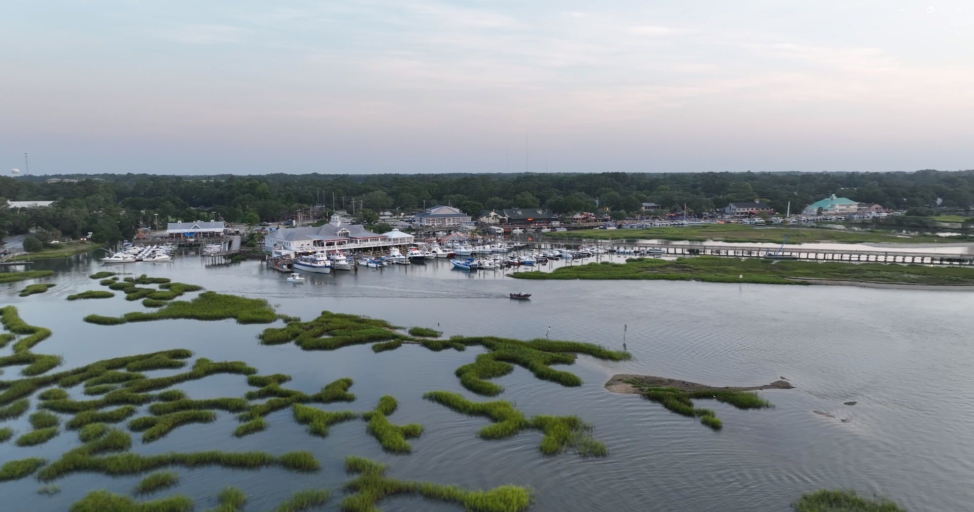 An aerial view of a large body of water with a marina in the background.