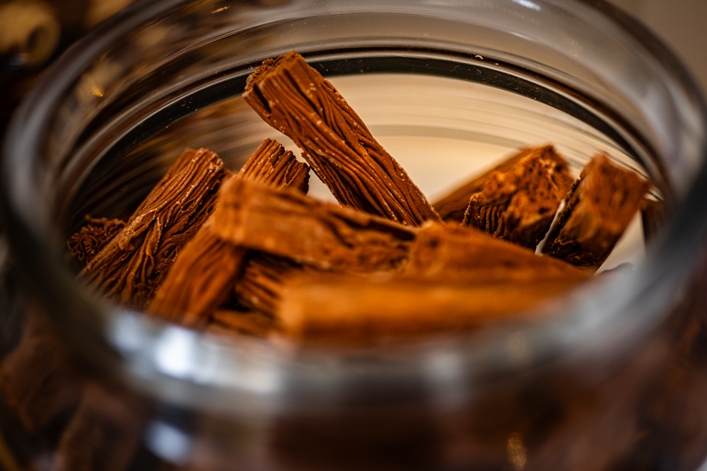 Chocolate wafer sticks inside a clear glass jar, viewed from above.