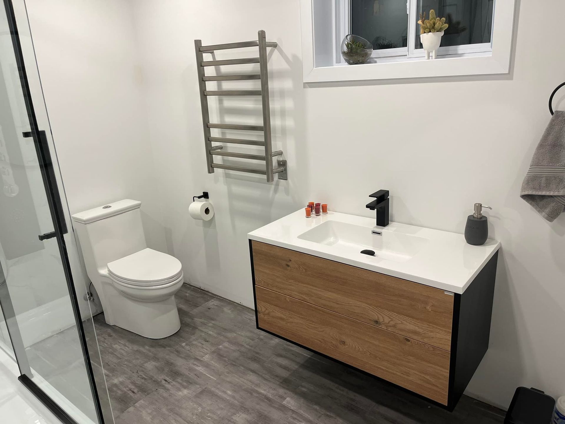 Une salle de bain avec WC, lavabo et douche.