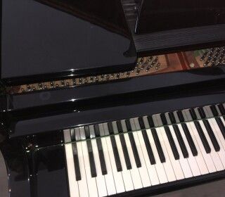 Un primo piano della tastiera di un pianoforte su un tavolo.