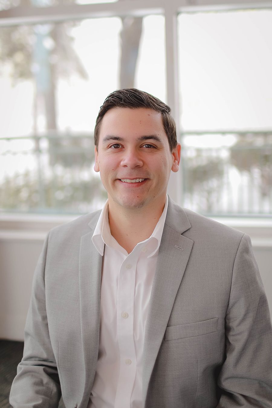 A man in a suit and tie is smiling for the camera.