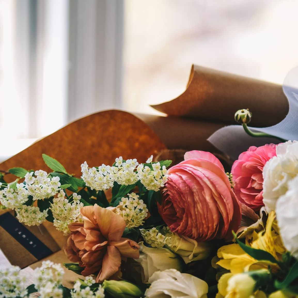 A guest book surrounded by flowers at a funeral