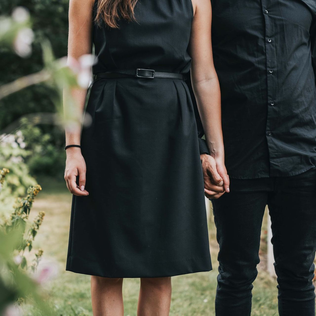 a couple holding hands at a funeral
