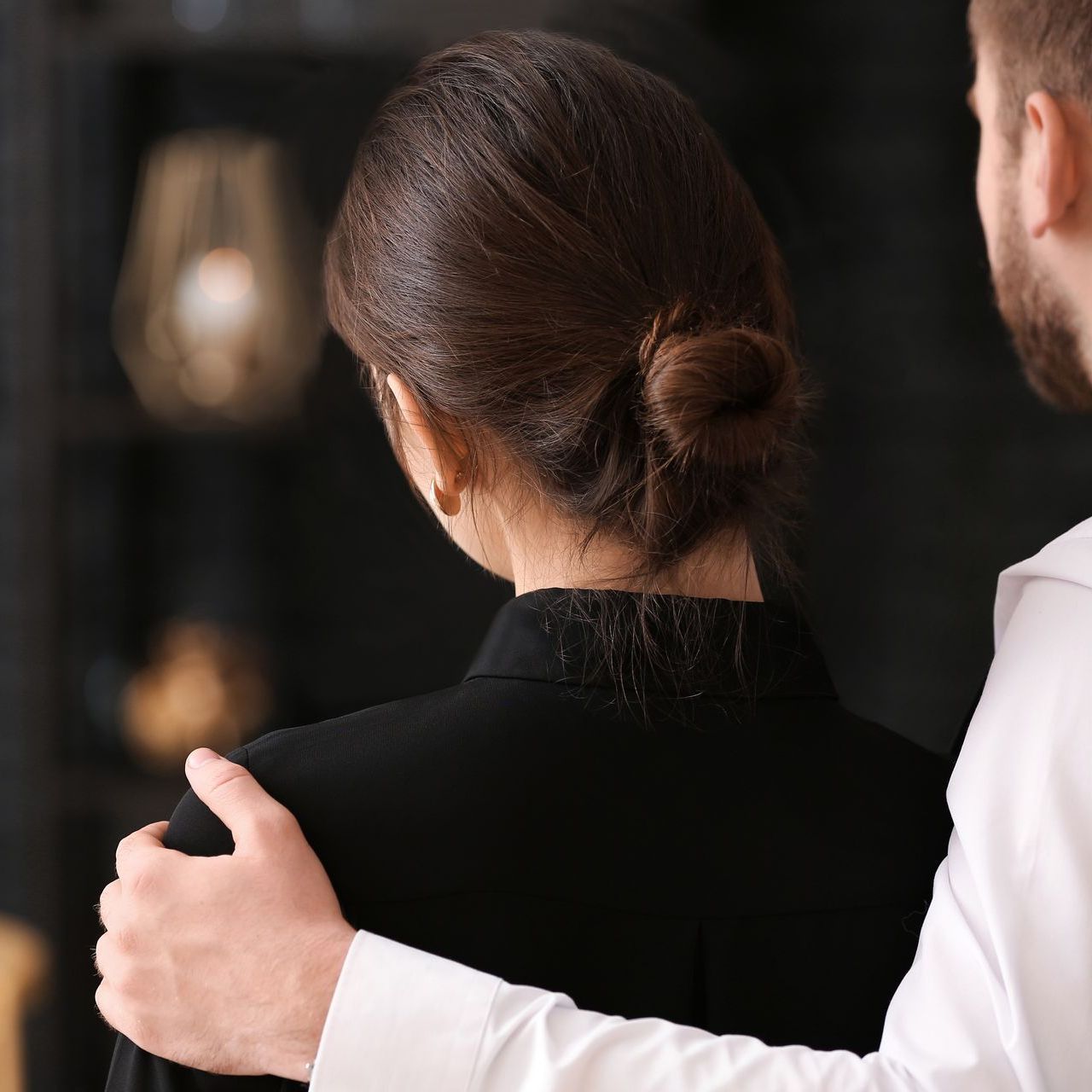 The back of a womens head with a low bun
