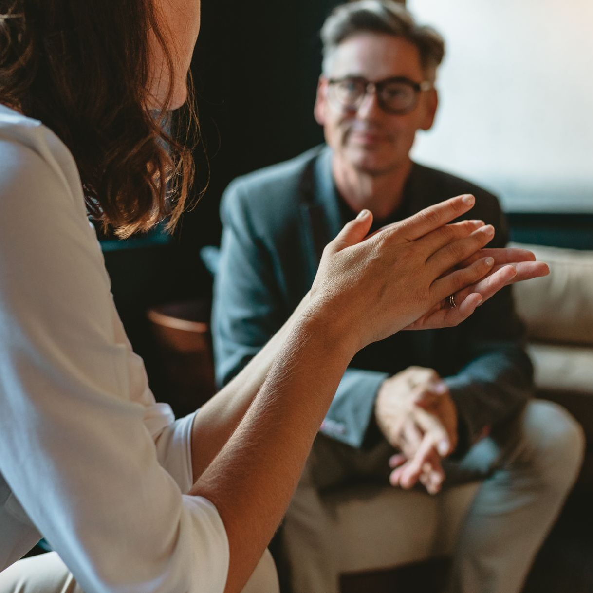 A woman talking to a man about something serious