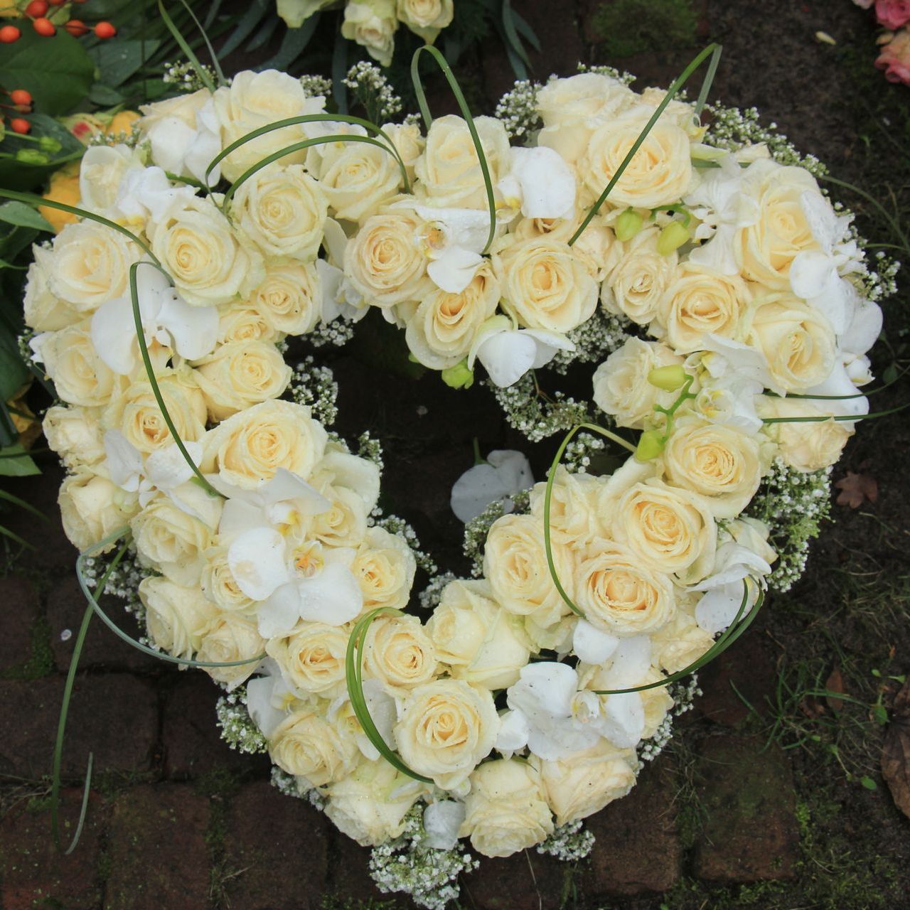 A bouquet of white roses in the shape of a heart