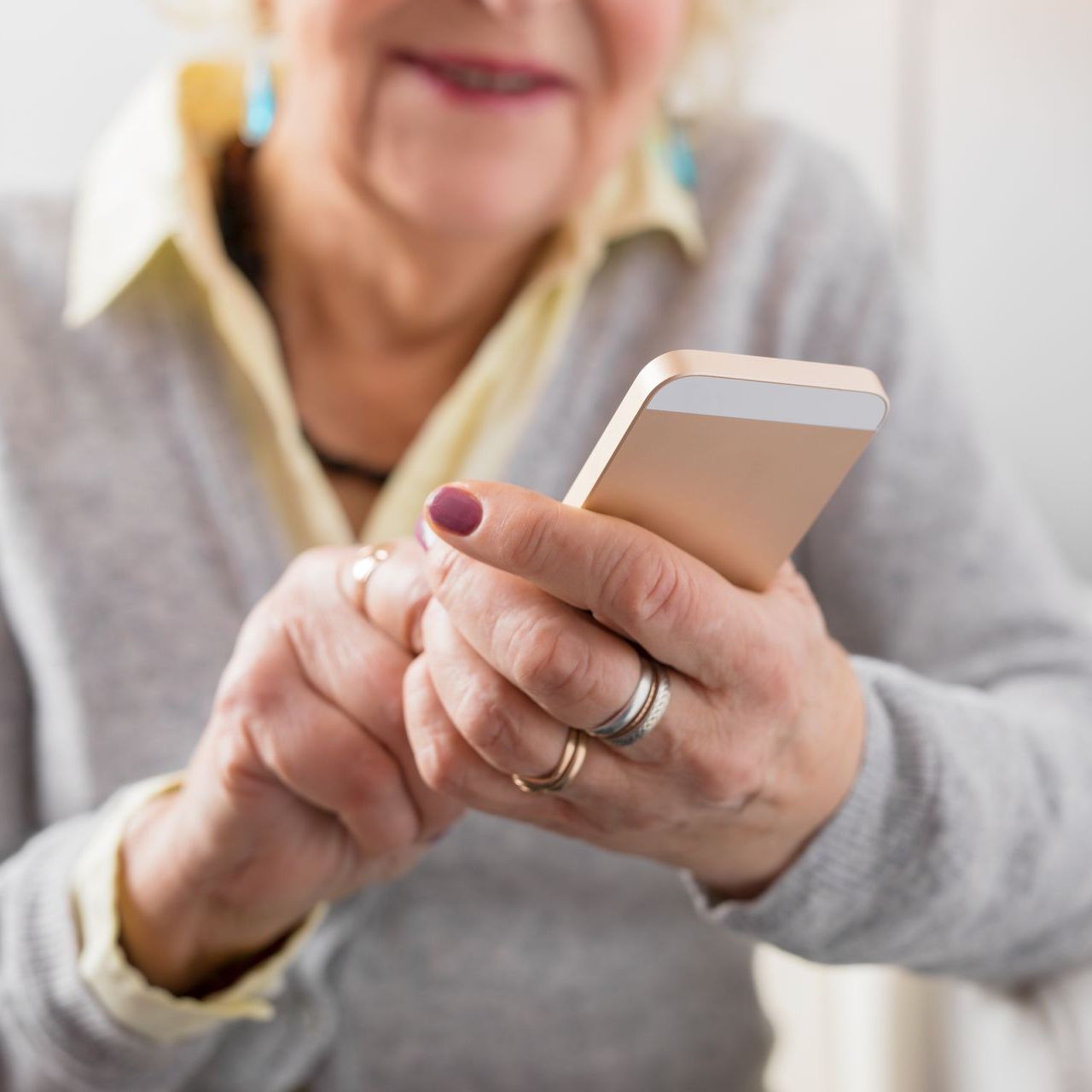 A photo of an elderly woman using her phone