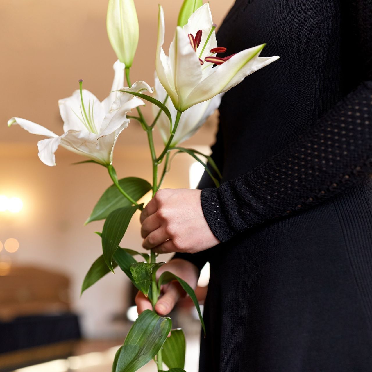 A woman holding lillies in her hands