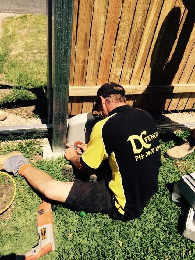 A man wearing a shirt that says dc on it — DC Fencing In Wondunna, QLD