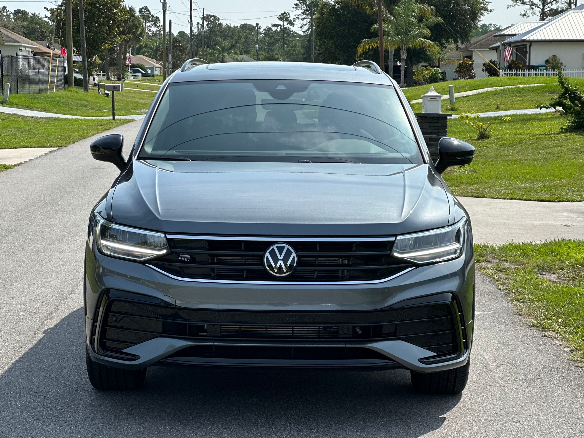 Front view of a black Volkswagen SUV parked on a residential street.