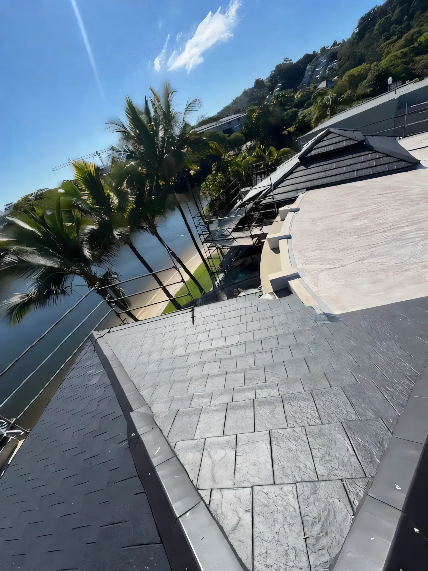 Metal roof on a building with a clear blue sky and green trees in the background. — Boostn Pty Ltd in Glastonbury, QLD 
