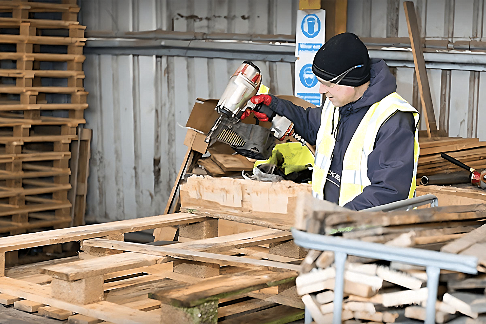 Man Refurbishing Wood Pallet